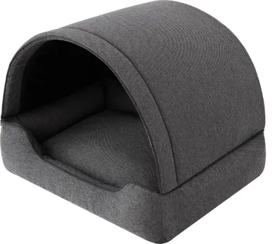 A dark gray pet bed with a hooded top.