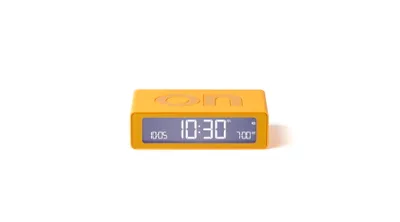 A yellow digital alarm clock is shown against a white background.