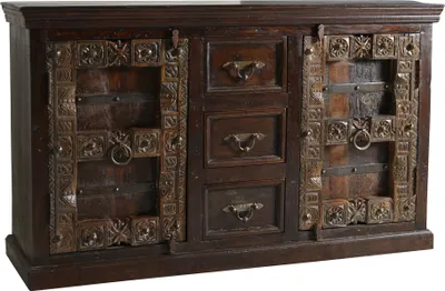 A dark wooden sideboard with ornate metal detailing on the doors and drawers.