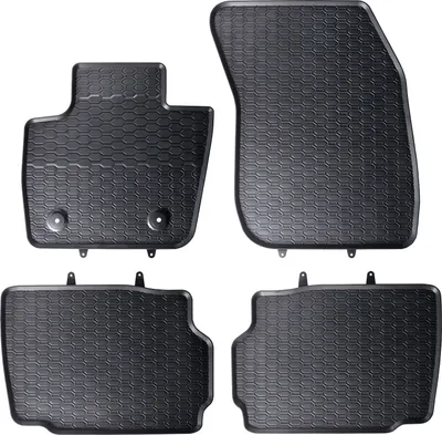 Four black rubber floor mats for a car, arranged in a studio setting against a white background.