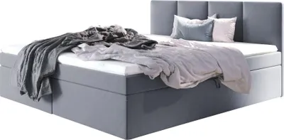 A bed with bedding and pillows.