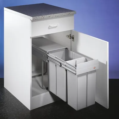 A white kitchen cabinet with a pull-out trash bin system containing two gray bins.