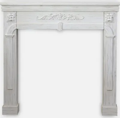 A white fireplace mantel with decorative carvings and a distressed wood finish.