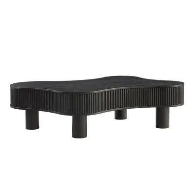 A black, uniquely shaped coffee table with a fluted design on its sides, shown from a side-angle against a white background.