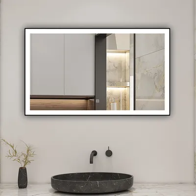 A modern bathroom with a large illuminated mirror above a dark marble sink.