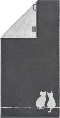 A dark gray towel with a white outline drawing of two cats sitting on a line.