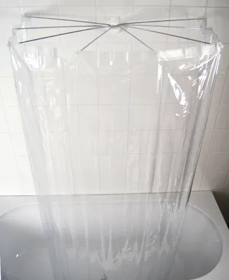 A transparent shower curtain hanging over a bathtub.