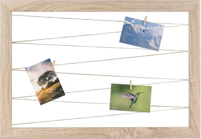 A wooden frame with strings holding four photographs.