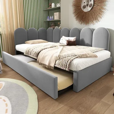 A child's bedroom with a grey upholstered bed frame and a pull-out trundle bed.
