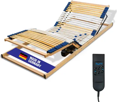 An adjustable electric bed frame with a remote control.