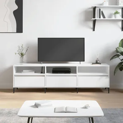 A white TV stand with a television on top, in a minimalist living room setting.