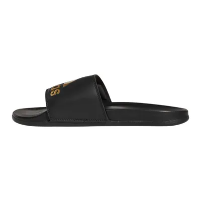 A side view of a black Adidas Adilette Comfort slide sandal with a gold Adidas logo on the strap.