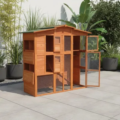 A wooden chicken coop with multiple compartments and doors, set up on a paved patio with plants in the background.