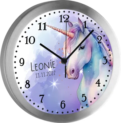 A close-up of a round wall clock with a unicorn design and personalized text.