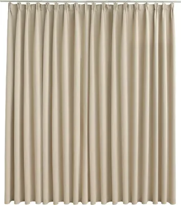 A full-frame shot of a beige curtain hanging from a rod.