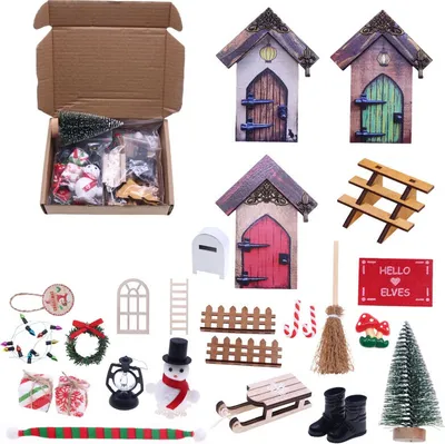 A collection of miniature Christmas-themed decorative items, including fairy doors, a snowman, a sled, a Christmas tree, and other accessories, arranged on a white background.