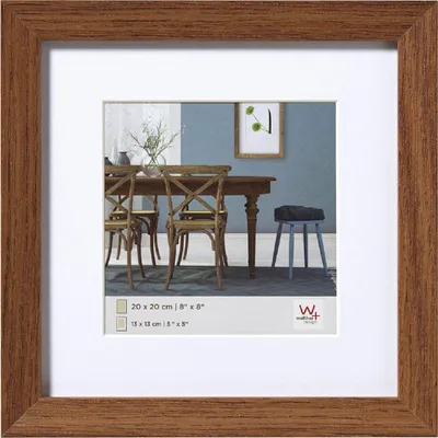 A framed picture of a dining room scene.