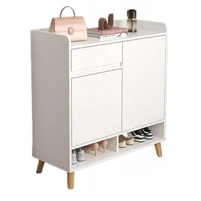 A white shoe cabinet with wooden legs, shown from the front.