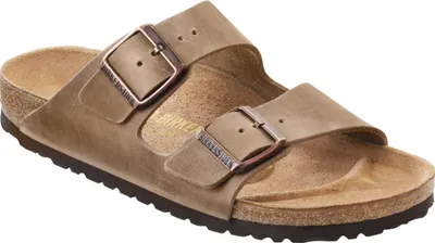 A pair of Birkenstock Arizona sandals in tobacco brown.