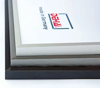 Close-up view of stacked picture frames with a logo and text on the white backing.