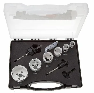 A set of hole saws and a drill bit in a black case with a clear plastic lid.