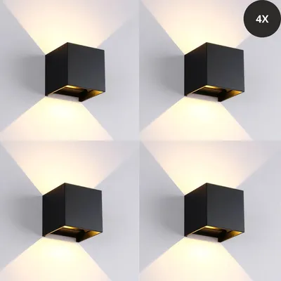 A collage of four identical wall lights mounted on a white wall, each casting light upwards and downwards.