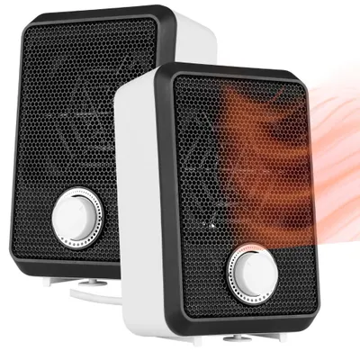 Two compact electric heaters are shown side-by-side against a white background. The heater on the right has a warm orange glow emanating from its grille, indicating it is in operation.