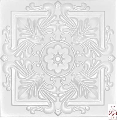 A white, embossed ceiling tile with ornate floral patterns.
