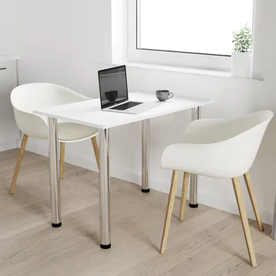 A white rectangular table with two white chairs and a laptop on it, placed in a bright room with a window.