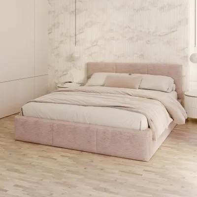 A bedroom scene with a pink upholstered bed.