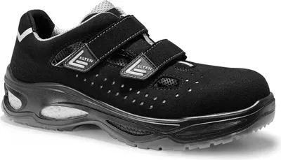 A black safety shoe with velcro straps.