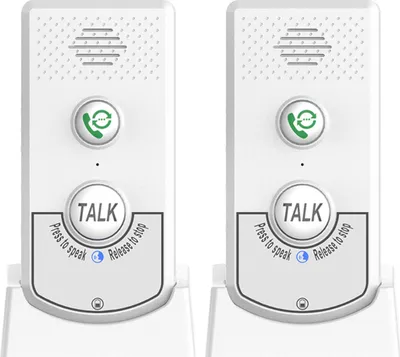 Two white wireless intercom units are shown side-by-side on their charging bases.