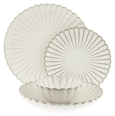 A set of white porcelain plates and bowls with a scalloped edge and silver trim, arranged on a white background.