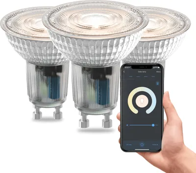 Three smart LED spotlights are shown, with one being controlled via a smartphone app.