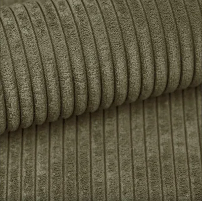 Close-up of textured olive green corduroy fabric, folded.