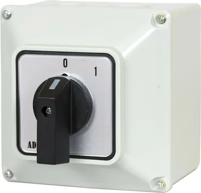 A white rotary switch in a protective enclosure.