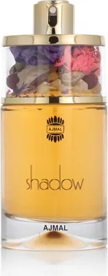 A perfume bottle with yellow liquid and dried flowers in the cap.
