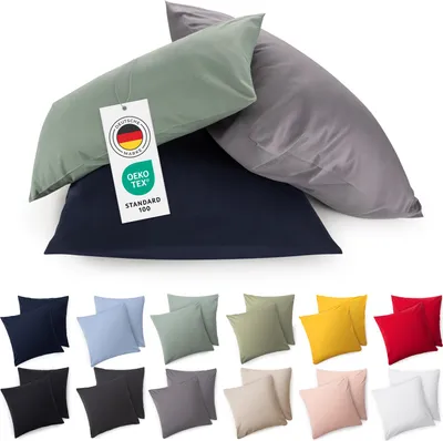 A collection of pillowcases in various colors, some stacked and some laid out in sets.
