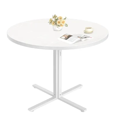 A round white table with a vase of flowers, a book, and a cup of coffee on it, set against a white background.