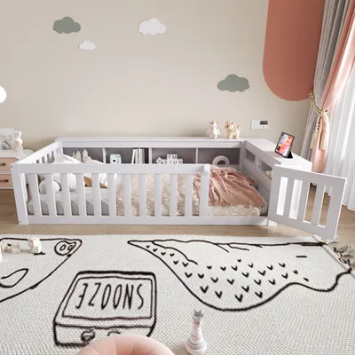 A child's bedroom with a white wooden bed frame, built-in shelving, and a rug with cartoon drawings.