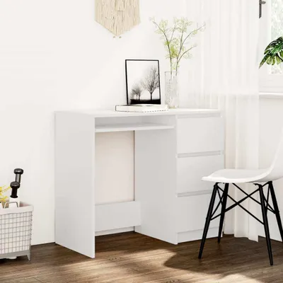 A white desk with drawers and a chair in a room with white walls and sheer curtains.
