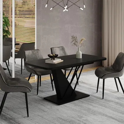 A dining room scene with a black dining table and chairs.