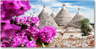 Produktbild von Tulup® Leinwandbild - 140x70 cm - Wandkunst - Drucke auf Leinwand - Leinwanddruck  - Sehenswürdigkeiten & Architektur - Rosa - Trulli Häuser