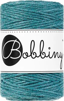 A spool of teal macrame cord with a label.
