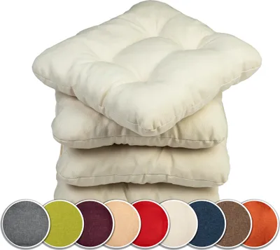 A stack of cream-colored seat cushions with a row of circular color swatches below them.