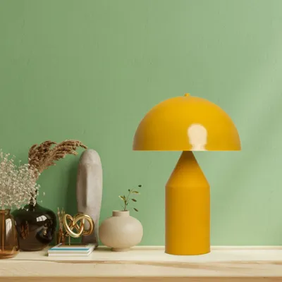 A yellow mushroom-shaped table lamp is displayed on a wooden shelf with various decorative items.