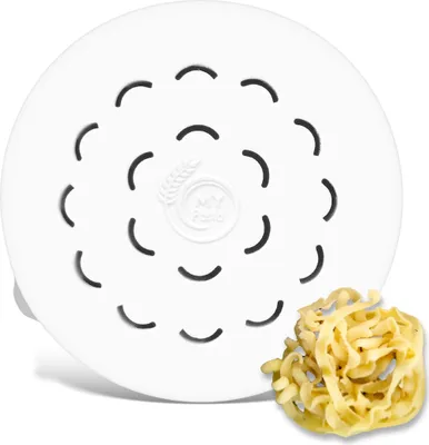 A white pasta maker disc with a small pile of cooked pasta.