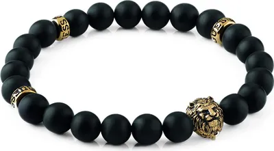 A bracelet with black beads and gold accents, including a lion head charm.