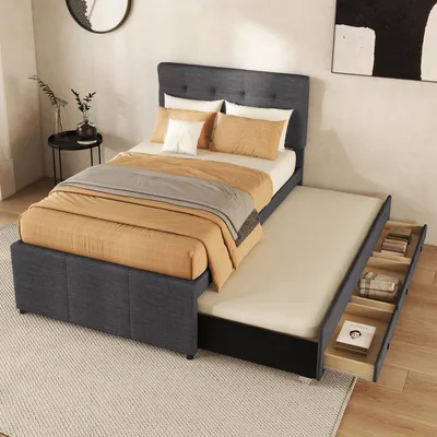 A bedroom scene with a bed that has a pull-out trundle and storage drawers.