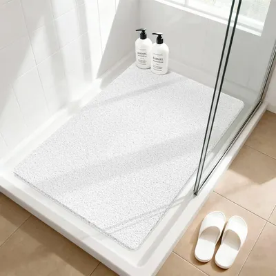 Obrázok produktu pre Protisklzová podložka pod sprchu, 60x90 cm, biela, vyrobená z PVC s textúrou podobnou ľufy, s odvodňovacími otvormi